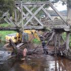 Otago Regional Council contractors remove a log from the Sir Truby King bridge in Tahakopa...