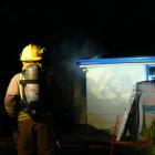 Firefighters attend a house fire in Nuggets Rd, the Catlins, yesterday evening. PHOTO:...