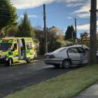 A white sedan crashed into a power pole, leaving its front driver's door crumpled and its...