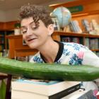 Children's book specialist Charlotte McKay checks out the cucumber left behind at the University...