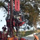 Peter Hopwood (left) and Jami Edgar, from McNeill Drilling, operate a deep soil drill at Tonga...
