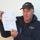 Hyde Cemetery Trust treasurer Martin Cameron holds a copy of a letter from Audit New Zealand...