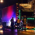 Police talk to the truck driver following the accident. Photo: Stephen Jaquiery