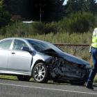 Senior Constable Bruce Dow, of Oamaru, checks a car that was struck by a train at a level...