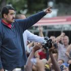 Venezuela’s President Nicolas Maduro gestures during a gathering outside Miraflores Palace in...