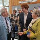 Current OUSA president James Heath speaks to Dunedin man David More and Karen Eagles, of New...