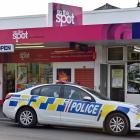 A police car is parked outside the On the Spot convenience store in Taieri Rd in Dunedin on...