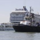 The towering cruise ship MSC Opera has struck a dock and a tourist river boat on a busy canal in...