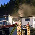 Firefighters at the scene of a house fire in Queenstown this morning. Photo: Stephen Jaquiery 