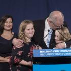 Australian PM Scott Morrison hugs his daughters Lily and Abbey as wife Jenny watches following...