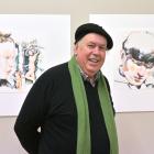 Artist and sexual abuse survivor Michael Haggie shows off two examples of his work at the opening...
