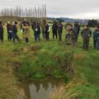 Visitors to a Waikoikoi water quality trial site last week inspect a sediment trap successfully...