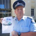 Senior Sergeant Jason McCoy, of Oamaru, with a home security questionnaire being handed out to...