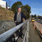 Standing on top of a half-finished retaining wall in Kaikorai Valley Rd is Dunedin businessman...
