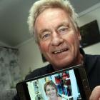 Heart-transplant recipient Alastair Gilchrist displays a photo of his daughter, Anna Milne, whose...