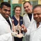 Holding a bull’s jaw are (from left) researcher  Jithendra Ratnayake, student Shay Taylor,...