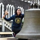 Human nutrition PhD candidate Claudia Leong prepares to give the University of Otago bell a whack...