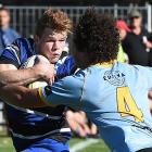 Kaikorai first five-eighth Ben Miller fends University lock Ben Reidy during a premier game at...