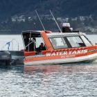 Dive squad members head out into the Frankton Arm to begin the search. 