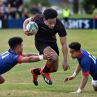 Waitaki Boys’ High School second five-eighth Semisi Kaufusi powers past St Kevin’s College rivals...