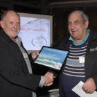 Search and Rescue district co-ordinator Brian Benn (left) presents Keith Simon with an...