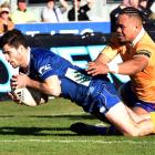 Otago halfback Rowan Gouws scores despite the efforts of North Otago replacement Toni Taufa...