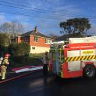 Firefighters at the scene of a blaze in Halfway Bush this morning. Photo: Gregor Richardson