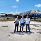 Wanaka Transport and Toy Museum owner Jason Rhodes (centre) in front of the former Air New...