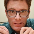 Dr James Scott, of the University of Otago, holds a 5cm-long piece of pallasite meteorite, which...