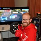 Champion Gran Turismo player Simon Bishop, at his racing console inside his Dunedin home. Photo:...