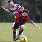 OMA United’s Raghdan Karim and Constable Aaron Burgess of the Blue n’ Gold Bobbies fight for the...