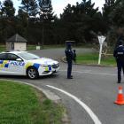 Armed police guard a rest area in Glenavy, north of Oamaru, yesterday while police conduct a...