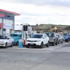 Vehicles line up at the Maheno service station to take advantage of cheap fuel yesterday. Photo:...