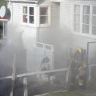 Dunedin firefighters battle a blaze on Puketai St. Photo: Gregor Richardson 