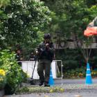 Police Explosive Ordnance Disposal (EOD) officers work following a small explosion at a site in...