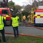 Fire crews at the scene of a house fire in Hillsborough on Tuesday. Photo: Mark Sinclair. 