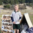 Terrace Primary School pupil Heidi Winter (10) shows off the fundraising stall that has...