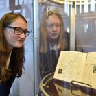 Otago Girls’ High School pupils Grace Twaddle (left) and Victoria Couper examine a replica of the...