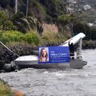 A boat covered in election signs for Cr Lee Vandervis, Russell Lund and Hilary Calvert is secured...