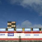 Signs advertising the benefits of life in one of Russell Lund's new Loan and Mercantile building...