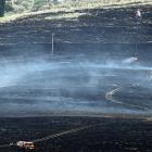 Battling a scrub fire in the Maniototo yesterday as it ravaged tussock and scrubland are a...