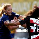 Trisha Hopcroft, of Otago Spirit, fends off Waikohika Flesher, of Counties-Manukau, during a...