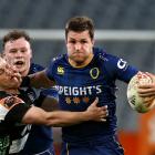 Otago captain Michael Collins fends off Brad Weber on the way to his side's win over Hawke's Bay...