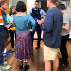 A police officer enters a school climate strike banner-painting session in Dunedin on Tuesday to...