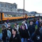 Tenth International Penguin Conference delegates depart from a Dunedin Railways train at Oamaru...