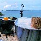 The divine decadence of twin outdoor tubs with an expansive view of sea, islands and sky. PHOTO:...