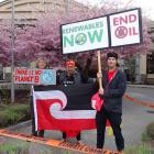Chris Naylor, Sina Brown-Davis, and David Patterson protest outside the Millennium Hotel. PHOTO:...