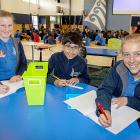 Maddy Hicks, 12, Khizar Abbas 11, and Xanthe Moore, 12 having class in the school hall. Photo:...