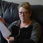 Dunedin bladder cancer patient Andrea Woodford holds a letter of apology sent to her by the...