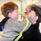 Dunedin Mayor-elect Aaron Hawkins is greeted by his son, Emile, at a victory party in a Dunedin...